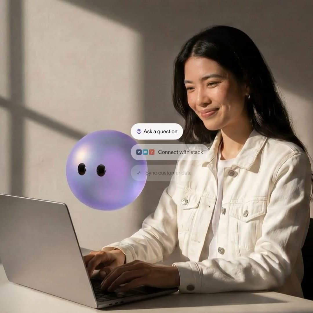 Person working at a laptop beside the Lyro agent, with prompts to ask a question, connect a stack, and sync customer data
